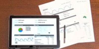 Image of a tablet displaying analytical graphs and charts meant to depict inventory management.